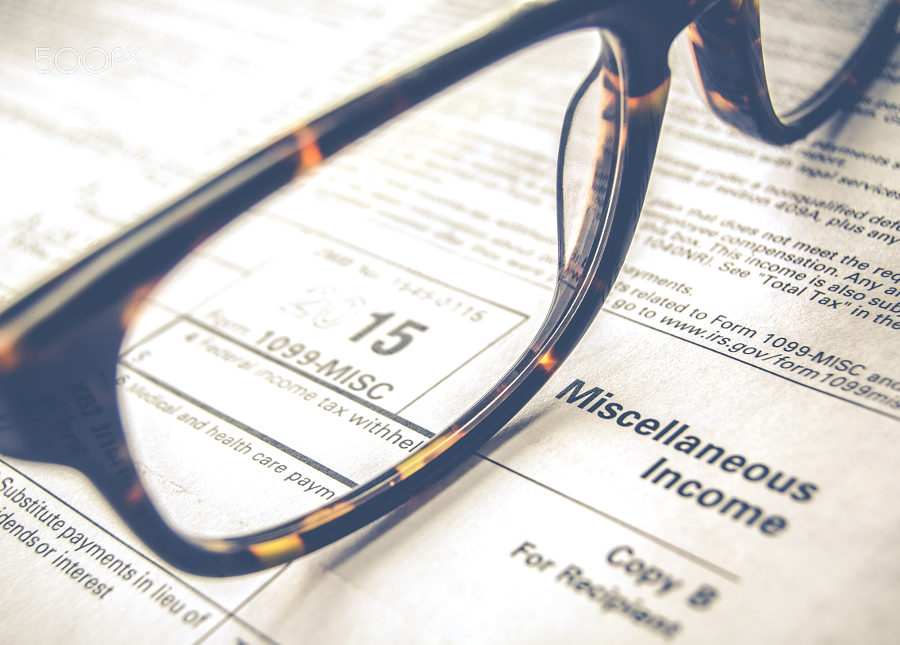 500px Photo ID: 145793597 - Retro Sepia Detail Of A Tax Form For 2015 Earnings For 2016 Tax Day With Glasses